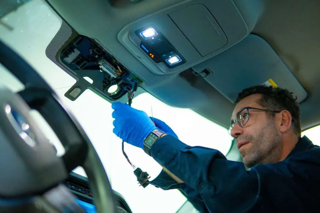 Windshield Surgeons technician performing service on complex ADAS hardware used for features such as lane change assist