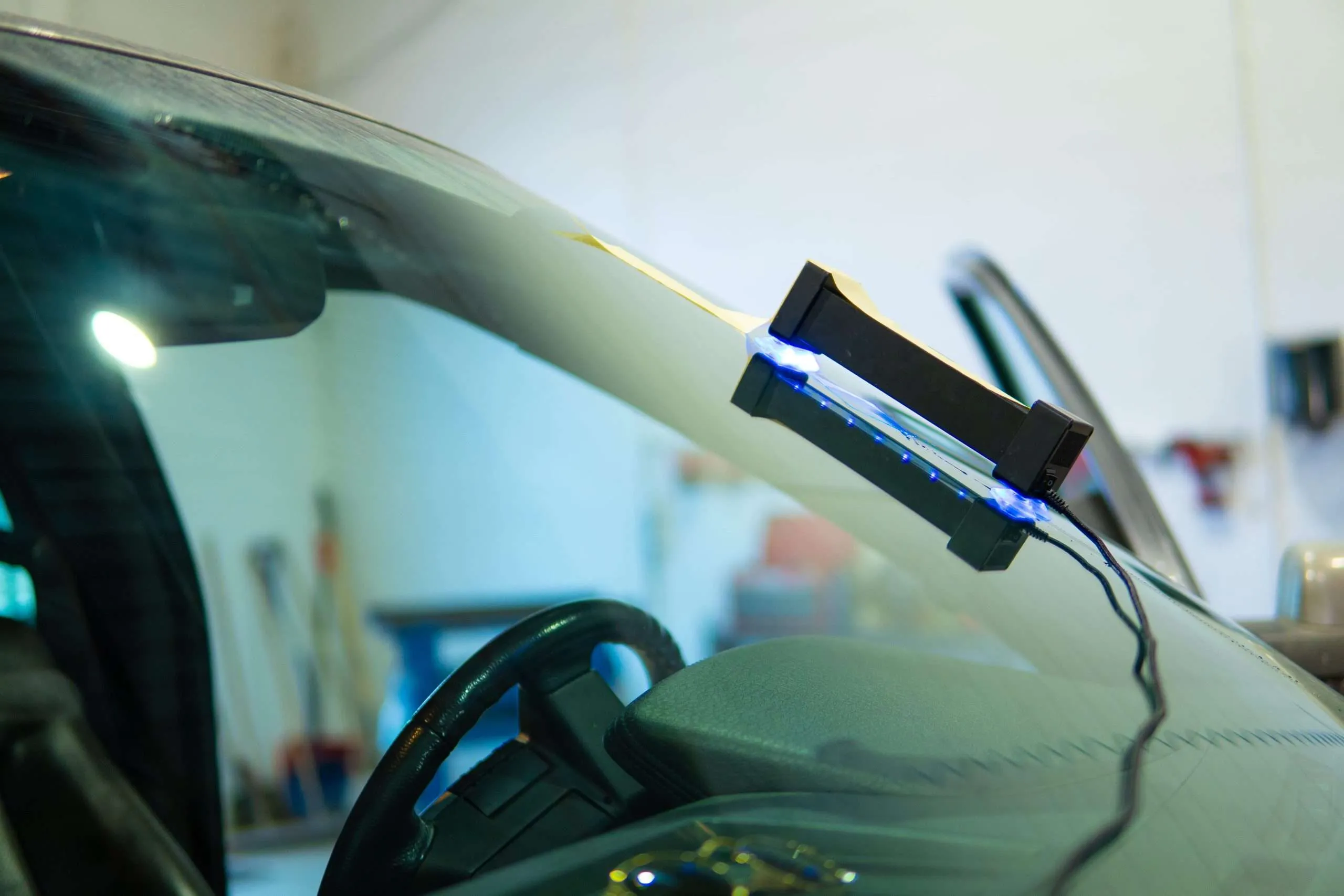 Close-up on a UV curing tool used for windshield repair