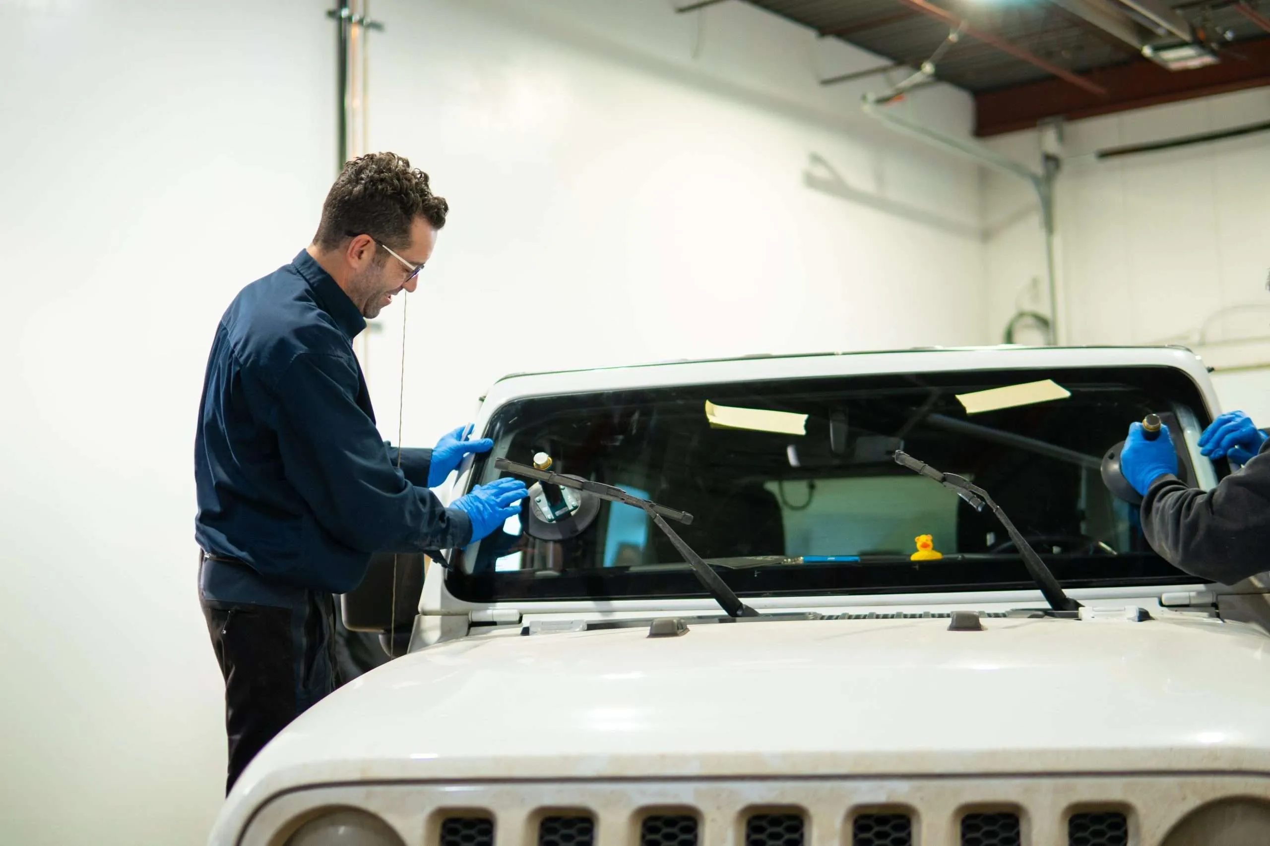 Windshield Surgeons technician performing an auto glass warranty replacement
