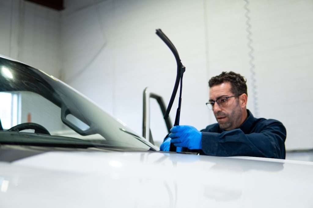 Windshield Surgeons Technician performing windshield and wiper blade maintenance