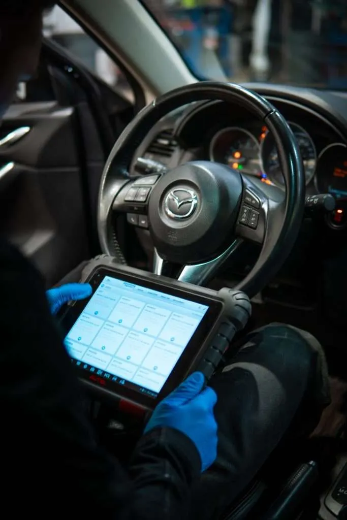 Close-up on an iPad being used by a Windshield Surgeons technician to perform ADAS Safety System Calibration