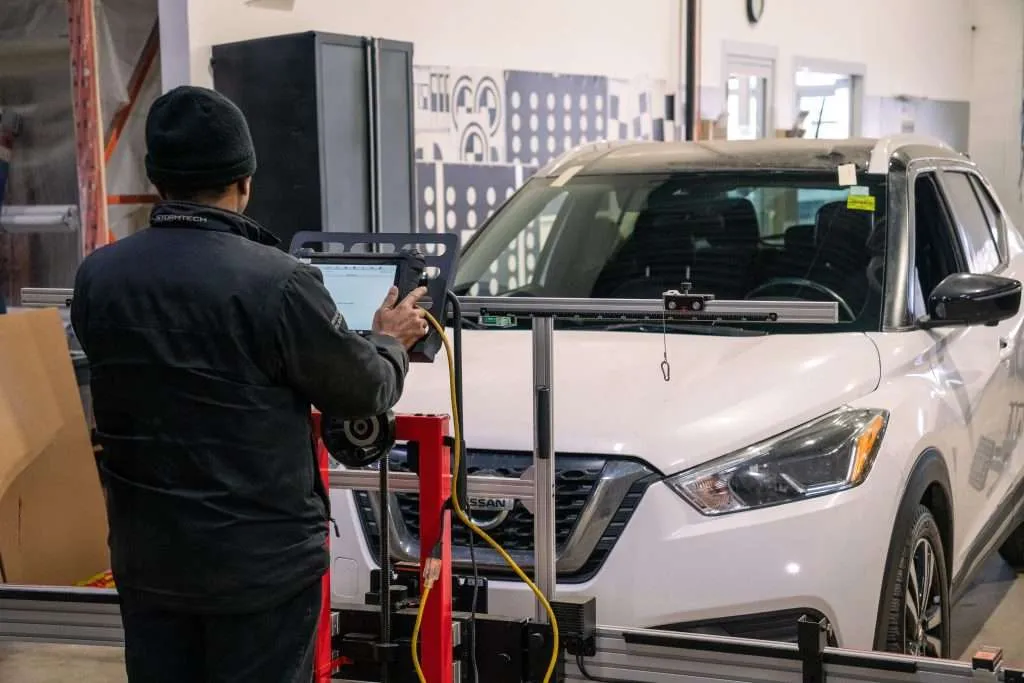 Windshield Surgeons technician performing ADAS calibration on a white SUV