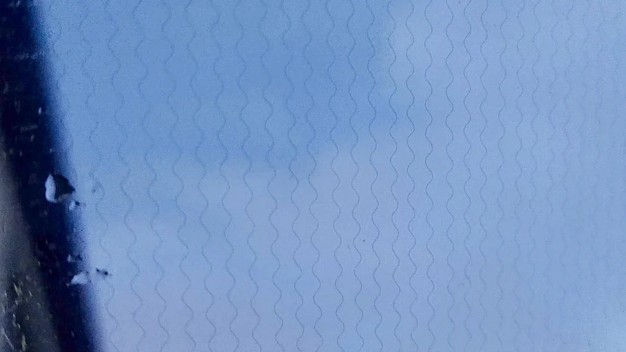 Extreme close-up on the thin heated filaments found within a fully heated windshield