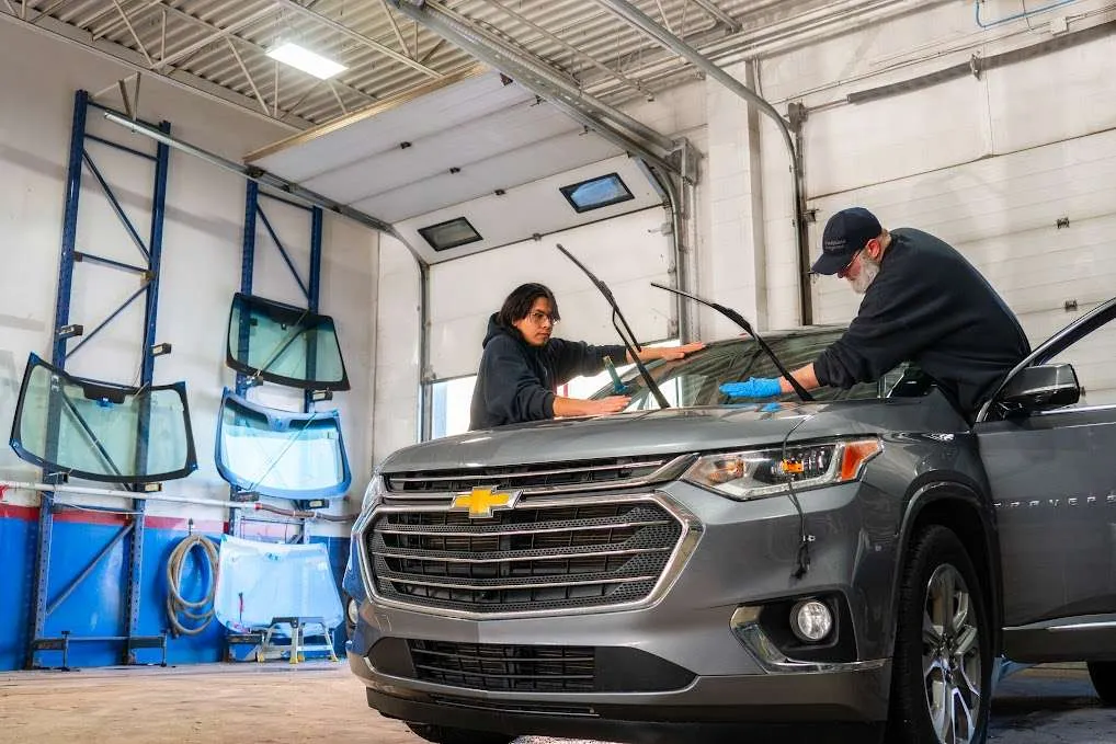 Two Windshield Surgeons technicians completing an auto glass replacement
