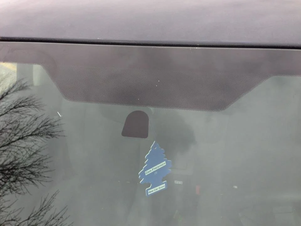 Windshield with a third visor frit pattern behind the rearview mirror area.