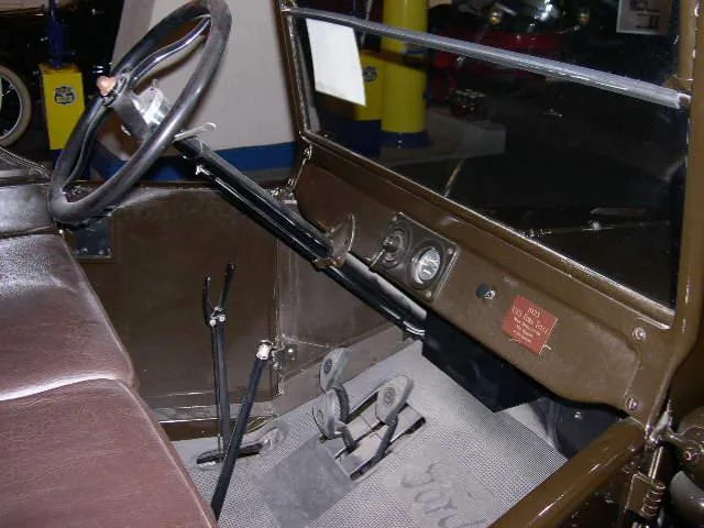 The interior of a Ford Model T with a two-part windshield